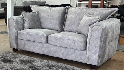 Serena Grey Two-Seater Sofa: Modern Quilted Design, Chic Metal Trim Accents